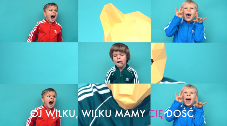 Kadr z teledysku Alicji Janosz Dzieciom – dzieci i napis „Oj wilku, wilku, mamy cię dość”