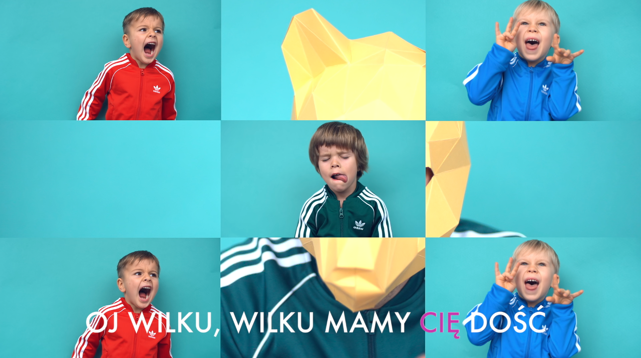 Kadr z teledysku Alicji Janosz Dzieciom – dzieci i napis „Oj wilku, wilku, mamy cię dość”